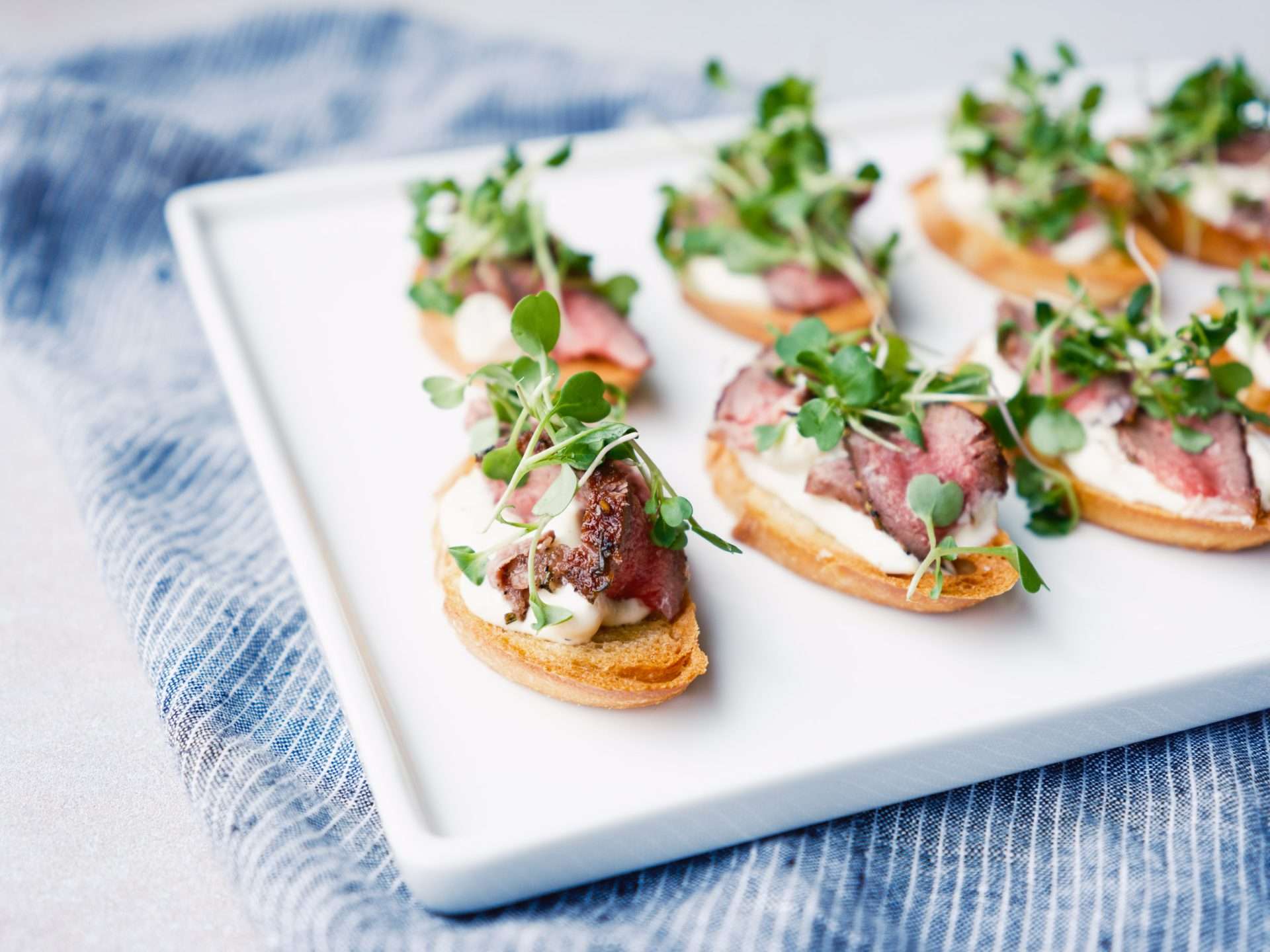 American Lamb Crostini with Blue Cheese Aioli and Arugula