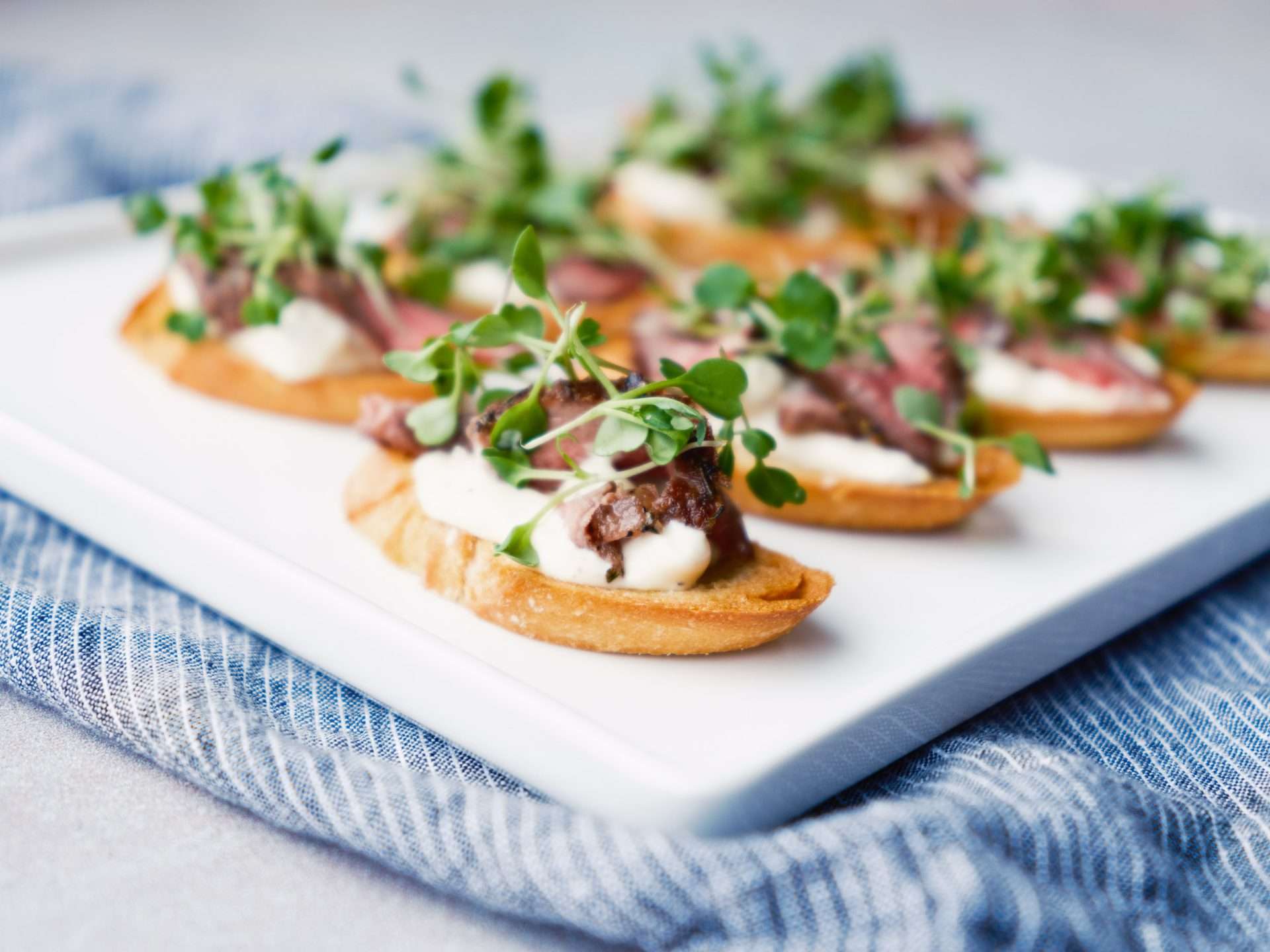American Lamb Crostini with Blue Cheese Aioli and Arugula