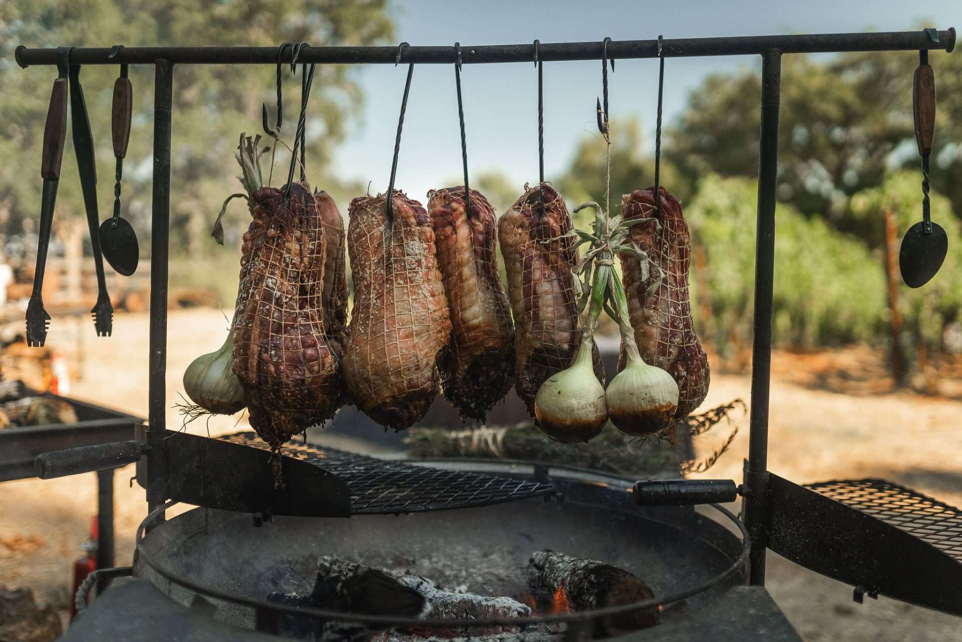 A photo of some lamb being hung over a grill
