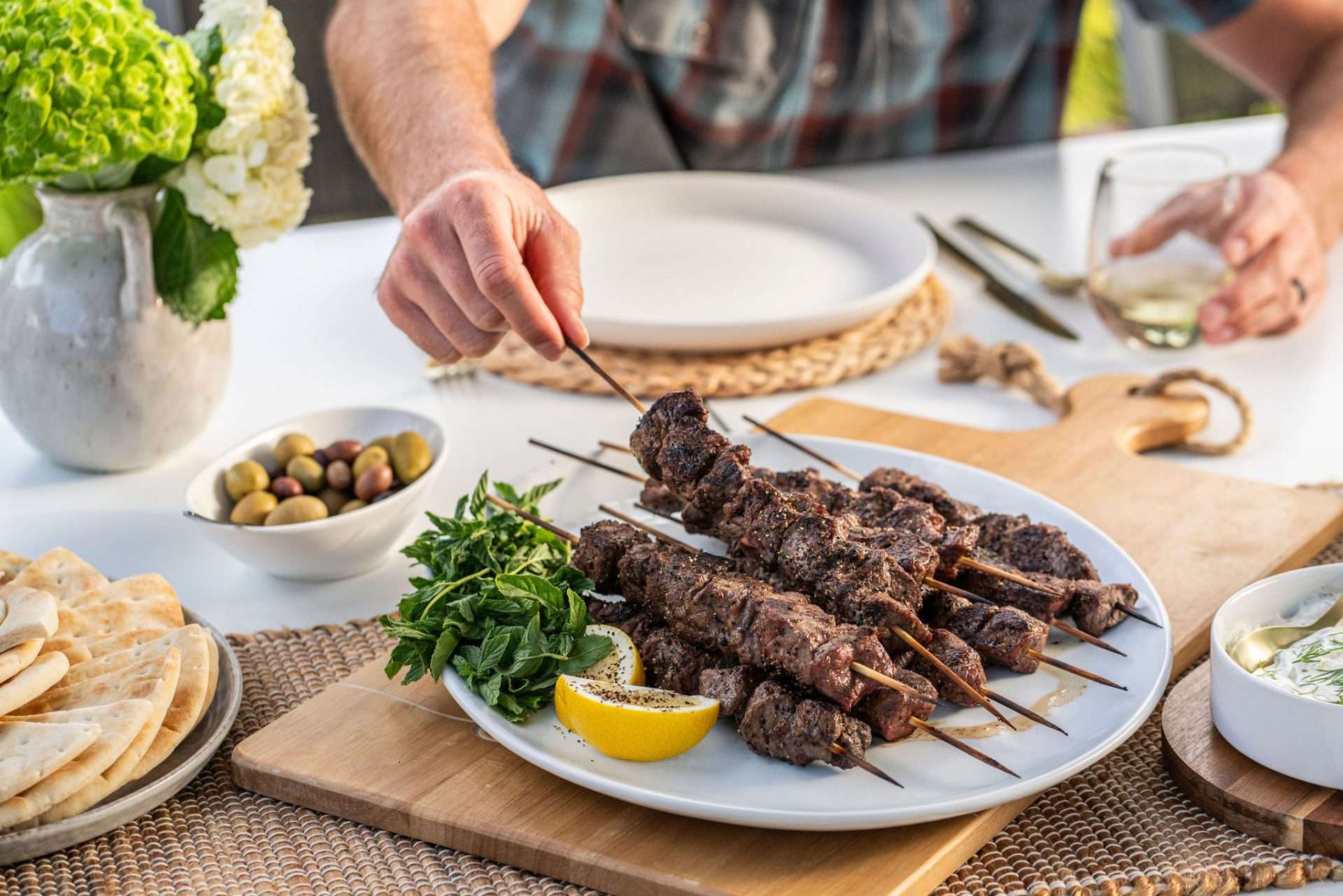Plate of lamb kabobs on a table for summer grilling