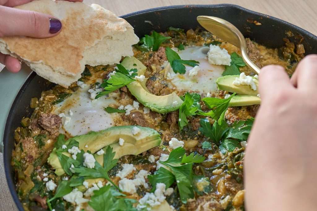 green shakshuka with lamb