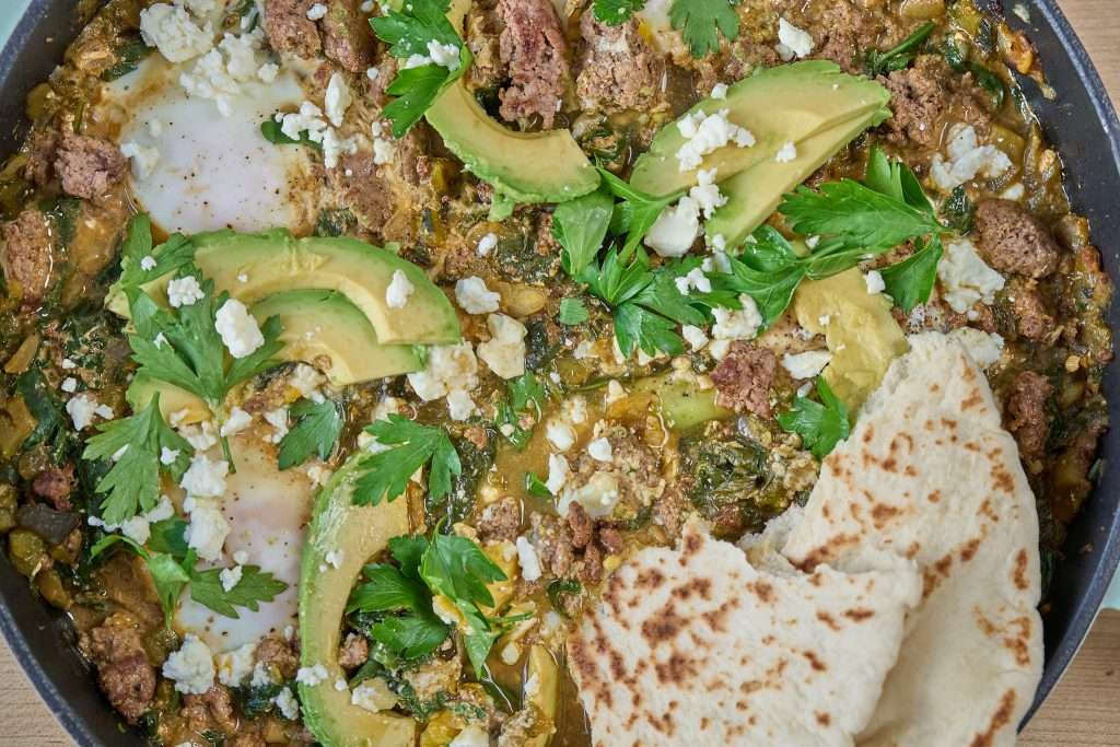 green shakshuka with lamb