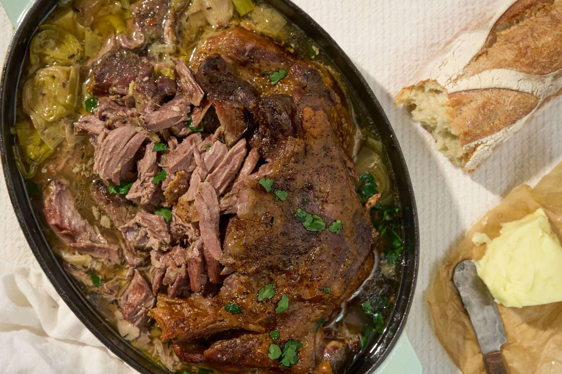 Slow roasted American lamb shoulder served with braised leeks in a white wine broth, topped with tender pulled lamb and fresh herbs.